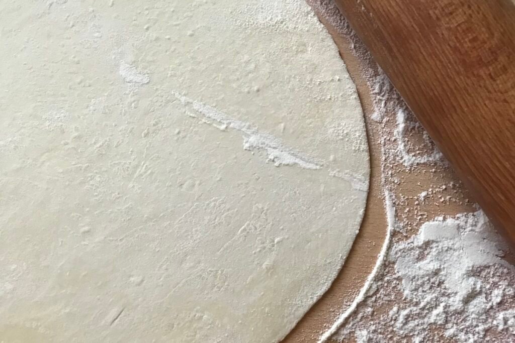Semolina vs Flour on a Pizza Peel: Which Should You Use? White flour powder on a wooden surface for pizza making