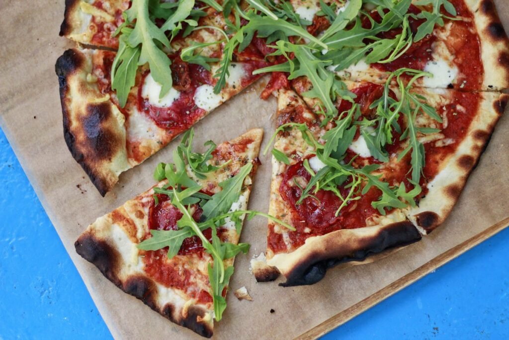 Gas vs Wood Pizza Oven: Which Is Better? Wood fire burning in a pizza oven