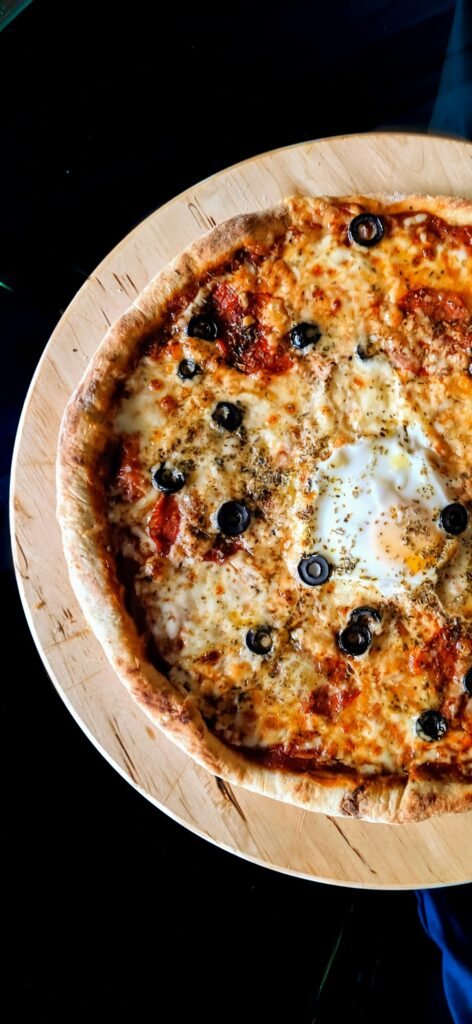 Ooni Karu 2 vs Karu 12: Is the Upgrade Worth It? Ooni Karu multi-fuel pizza oven cooking a pizza outdoors