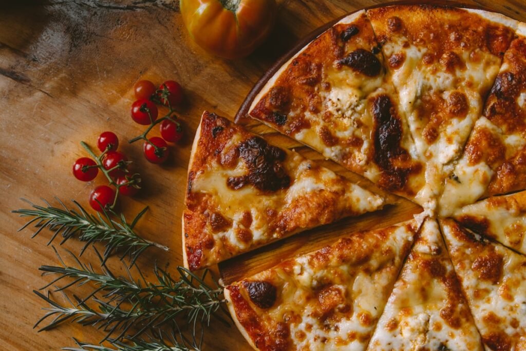 Ooni Karu 2 vs Karu 16: Which Multi-Fuel Oven Should You Buy? Ooni Karu multi-fuel pizza oven cooking pizza outdoors