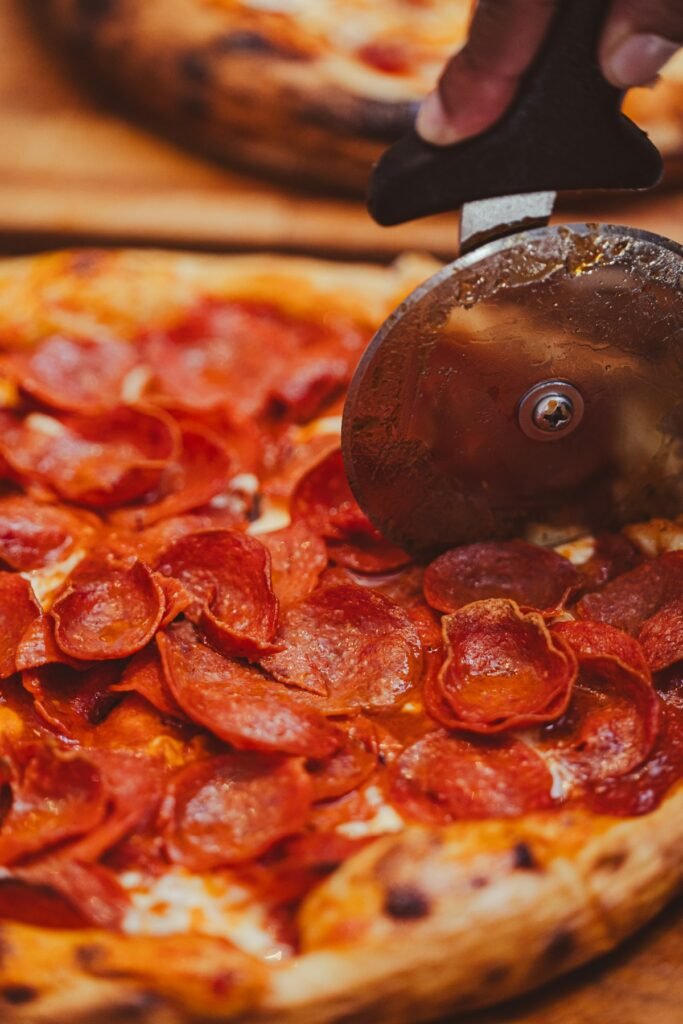 Best Pizza Cutters: Rocker vs Wheel, and Which to Buy Slicing pizza with pizza cutter