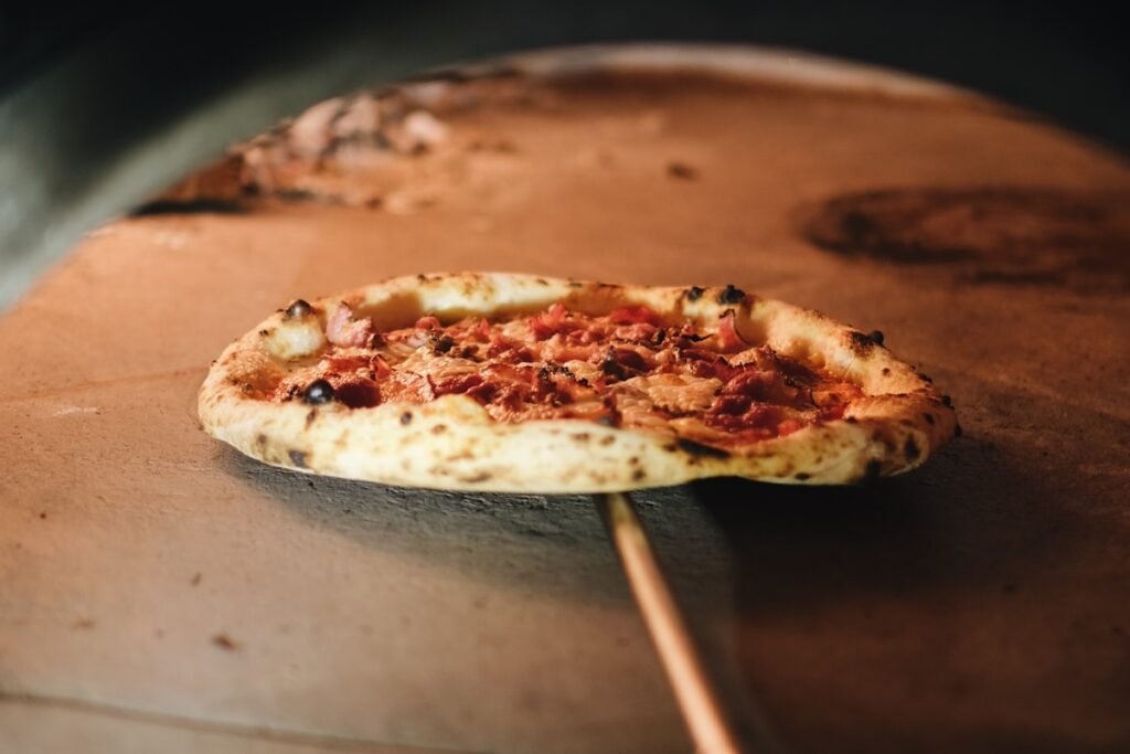 Best Wood-Fired Pizza Ovens for Backyard Use Pizza sitting on top of a wood-fired pizza oven